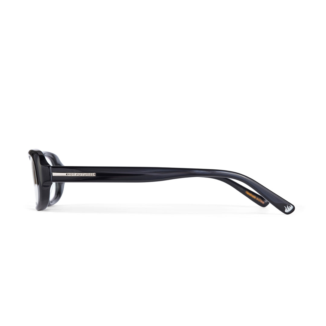 Black eyeglasses by hot futures shot from the side against a white background