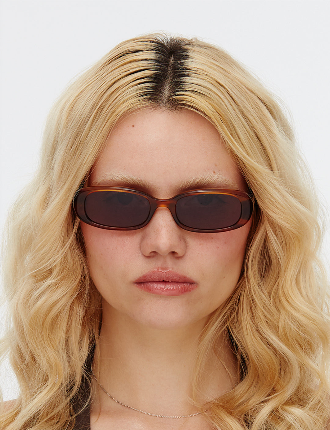 Model is wearing the Hot Futures Aurora Rectangle Slim Fit Sunglasses in Eco Caramel/Dark Green