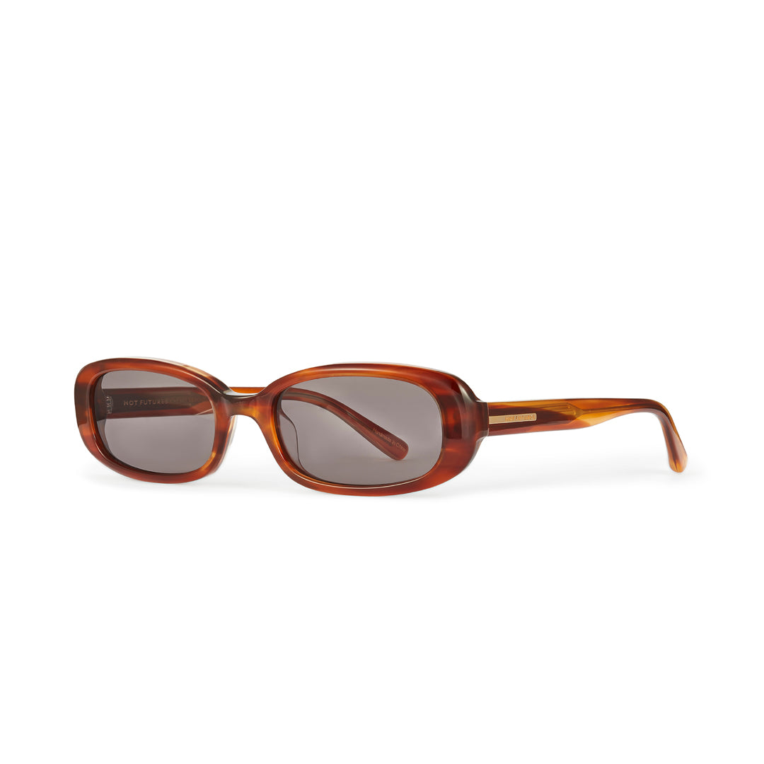 The Hot Futures Aurora Eco Caramel Dark Green Sunglasses from a side angle with the arm shown. The arm has gold Hot Futures minimal logo down the side.