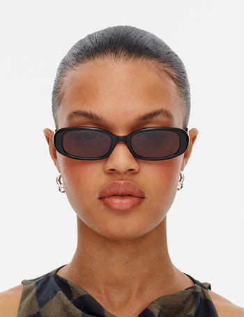 Model Wearing Hot Futures Aurora Slim Rectangular Gloss Black Sunglasses