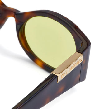 Sunglasses with tortoiseshell frame and gold accent on a white background