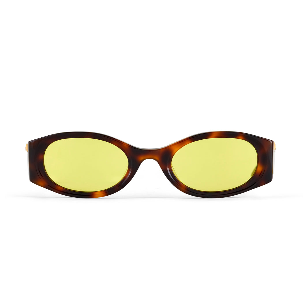 Sunglasses with tortoiseshell frame and yellow lenses on a white background