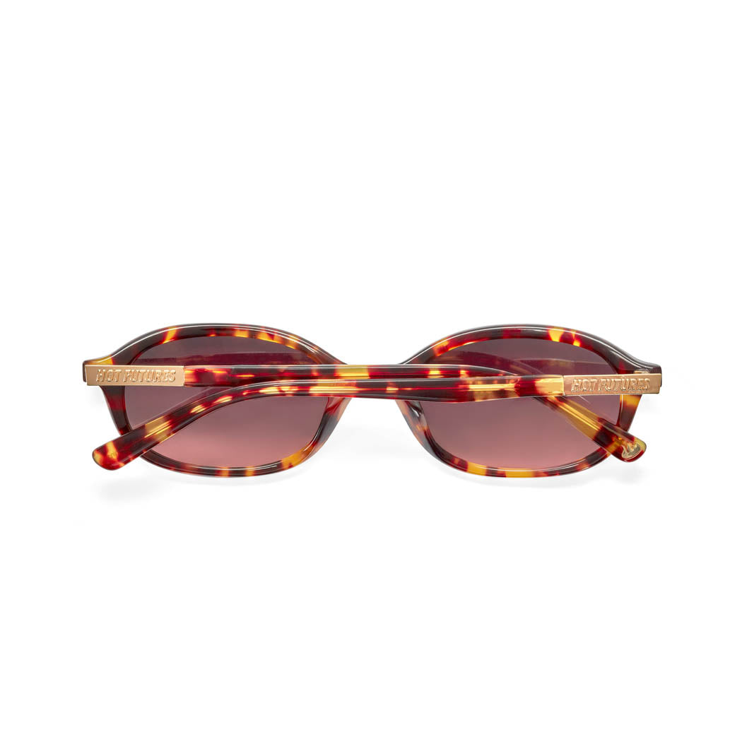 back shot of the cupid tortoiseshell sunglasses folded against a white background