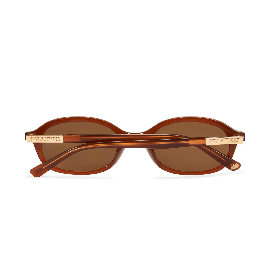 back shot of the cupid caramel sunglasses folded and flat against a white background