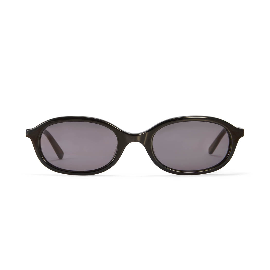 A pair of black oval sunglasses with smoke-coloured lenses, designed in a 90's revival style.