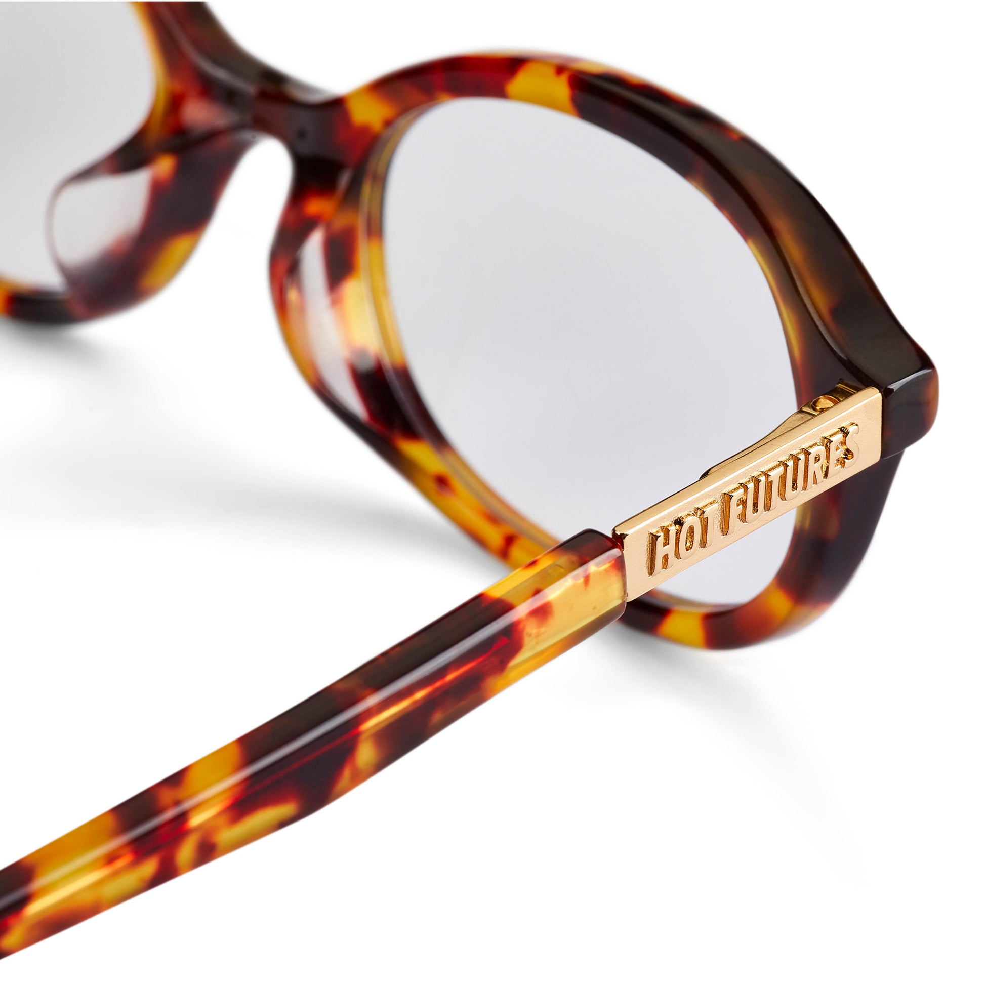 Tortoiseshell glasses with gold frame and 'Hot Futures' gold branding on a white background