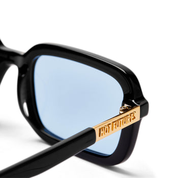 Close up of the Hot Futures dazed gloss black frame sunglasses with the light blue clear lens