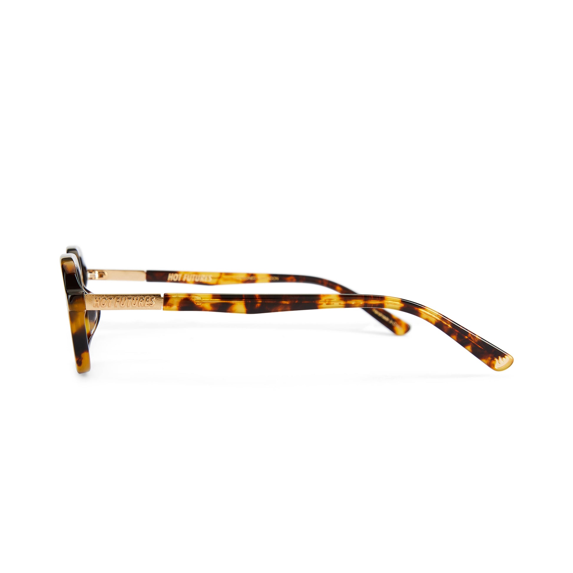 A pair of eyeglasses with a tortoiseshell pattern frame and clear lenses, featuring a Y2K inspired design with a slim rectangle frame.