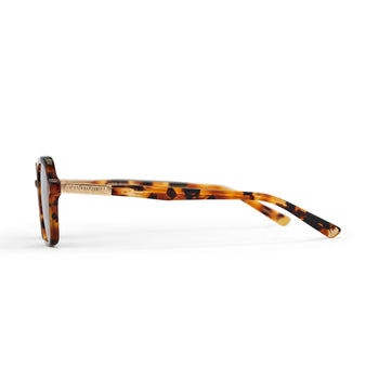 A pair of tortoiseshell patterned sunglasses with a slim rectangular aviator frame 
