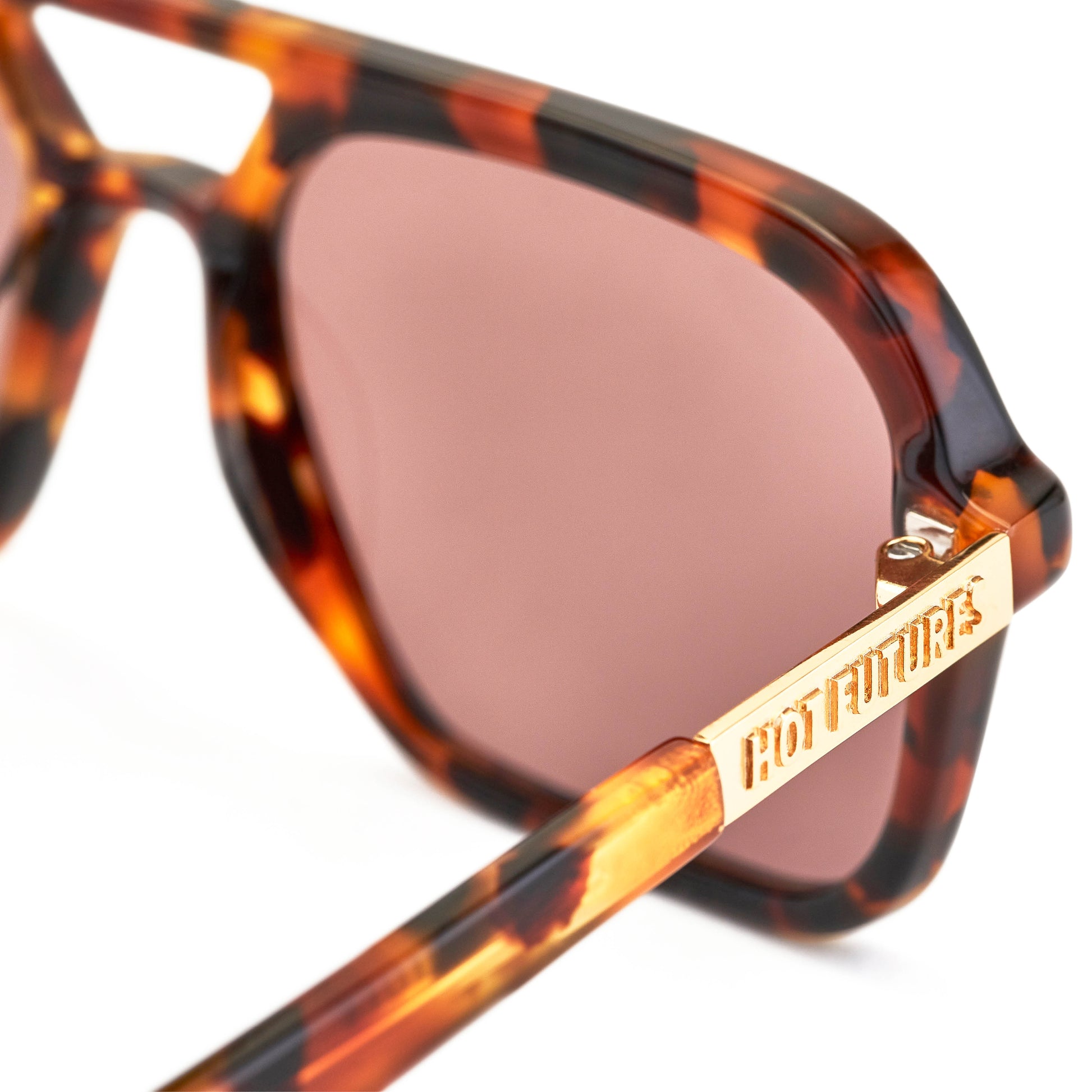 A pair of tortoiseshell patterned sunglasses with a slim rectangular aviator frame 