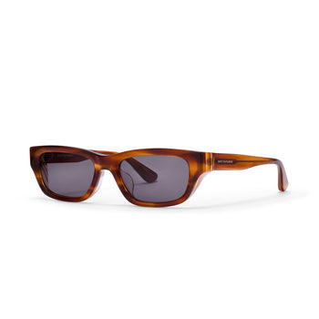 Sunglasses with tortoiseshell frame and dark lenses on a white background