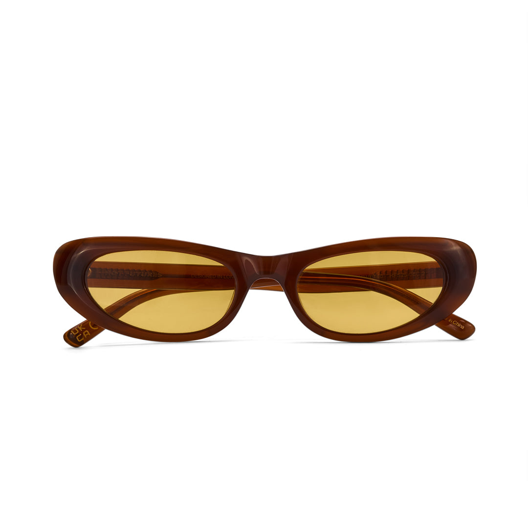 Brown sunglasses with yellow lenses on a white background