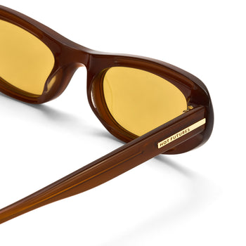 Brown sunglasses with gold lenses on a white background