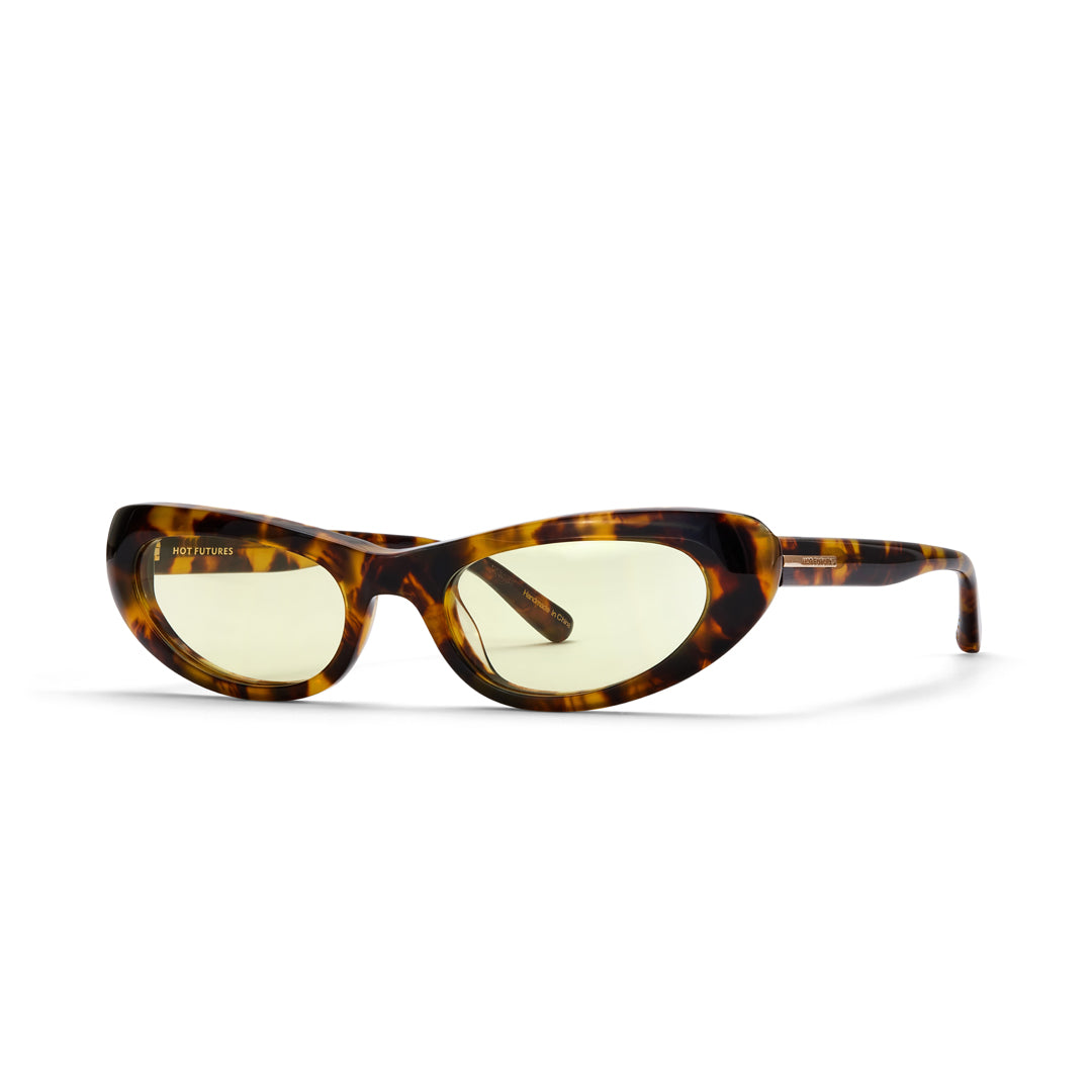 Sunglasses with tortoiseshell frame and yellow lenses on a white background