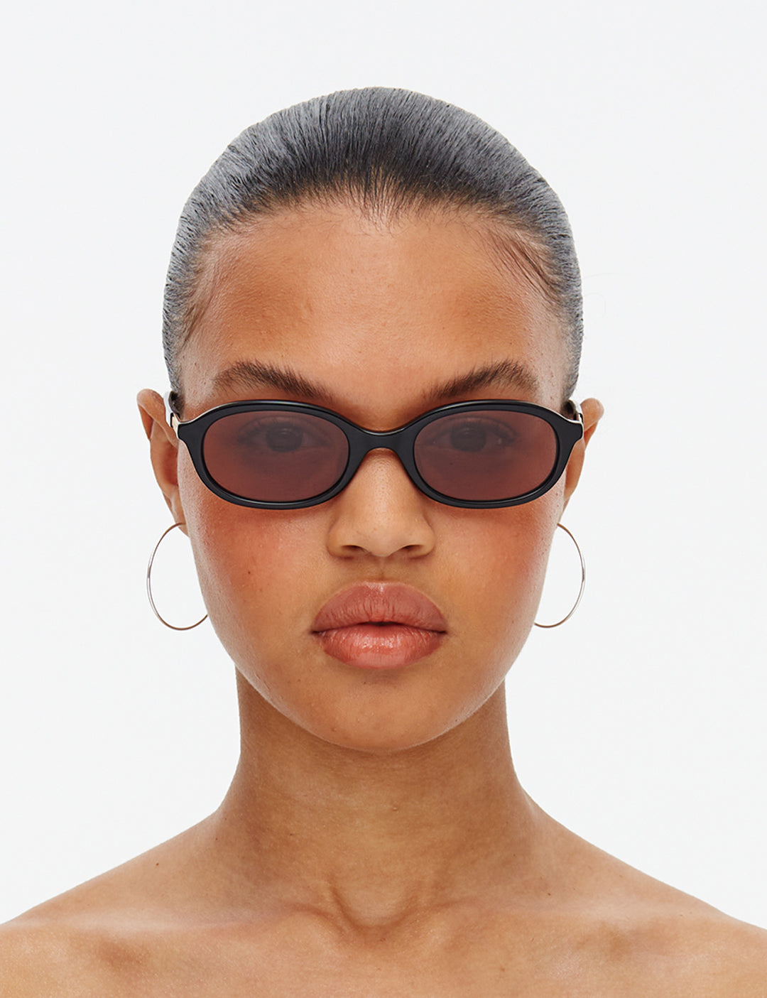 The Cupid Hot Futures Black sunglasses with brown-tinted lenses on a white background