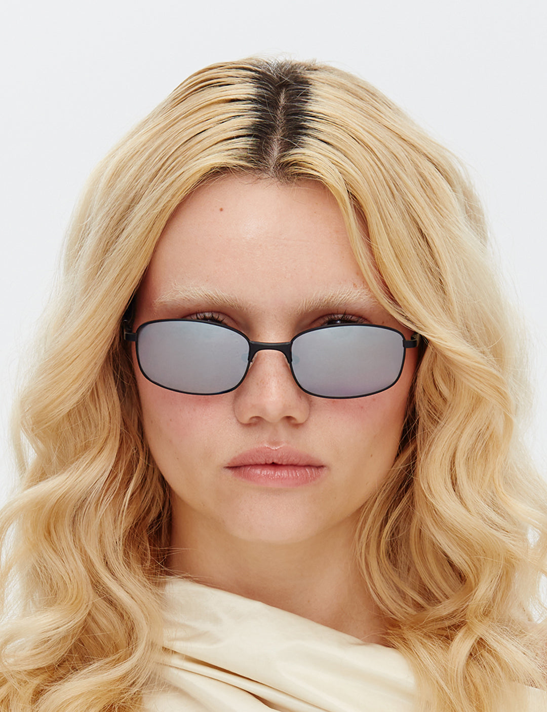 Person wearing the Blaze Black & mirror lens sunglasses with a neutral background