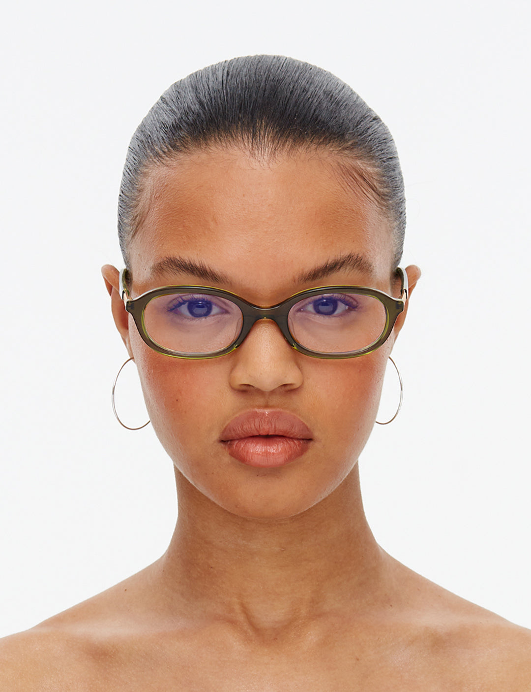 Woman wearing glasses with a plain background