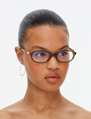 Woman wearing glasses with a plain background