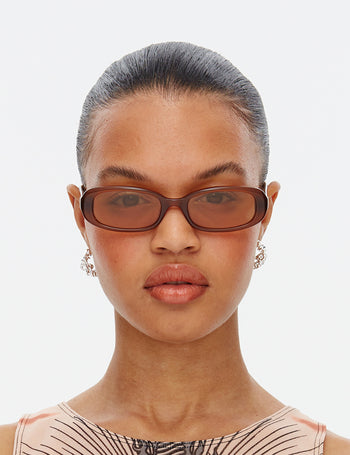 Model wearing Hot Futures Brown gold Aurora Category 1 Sunglasses. 