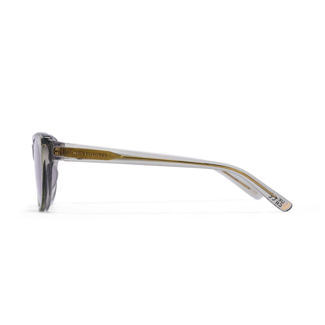 Sunglasses with gold frame and clear arms on a white background