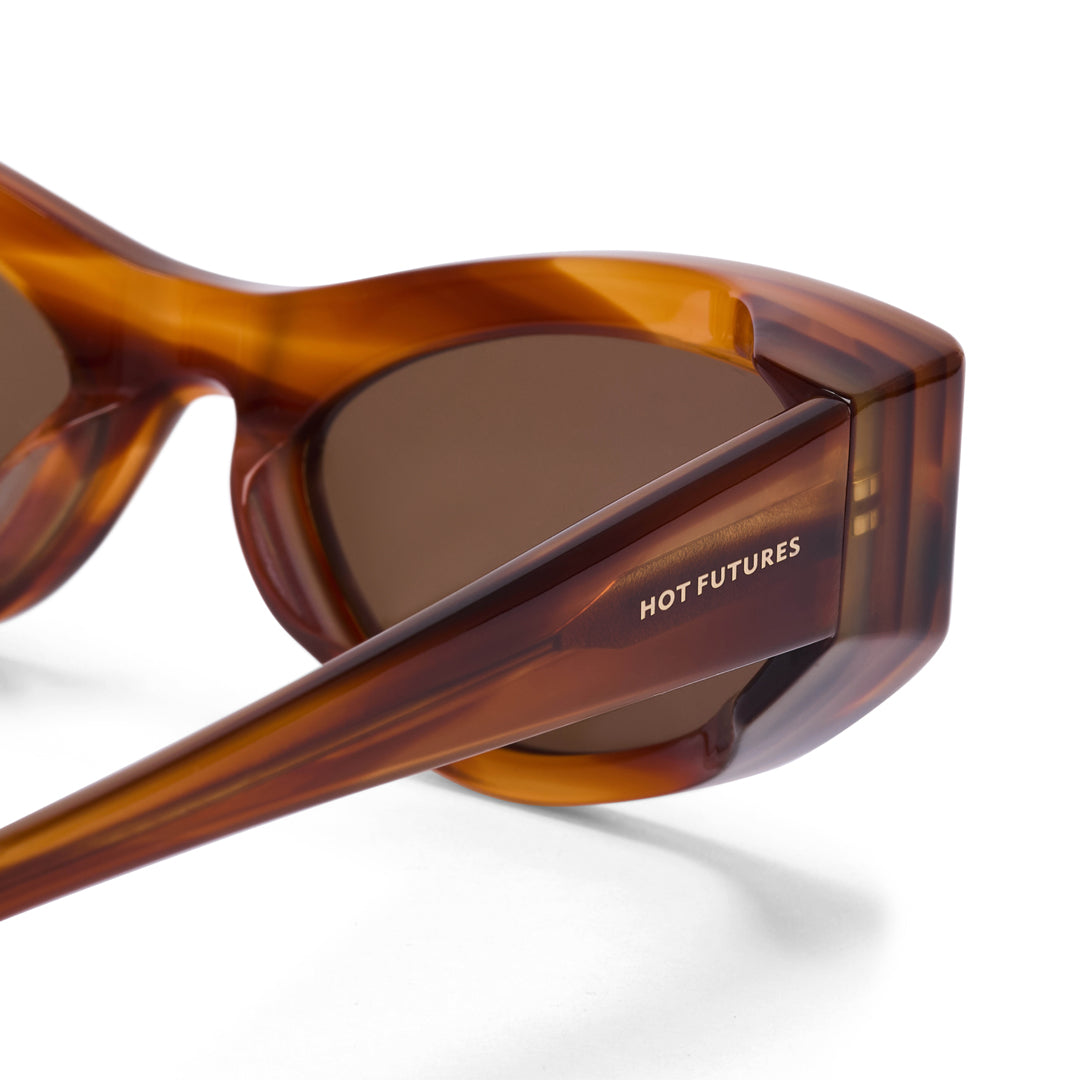 Brown sunglasses with 'HOT FUTURES' branding on a white background